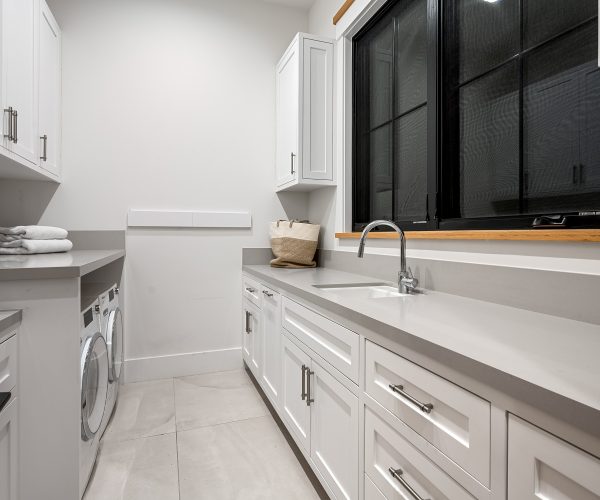 bright-laundry-room-with-white-cabinets-and-counte-2026-03-18-16-14-36-utc